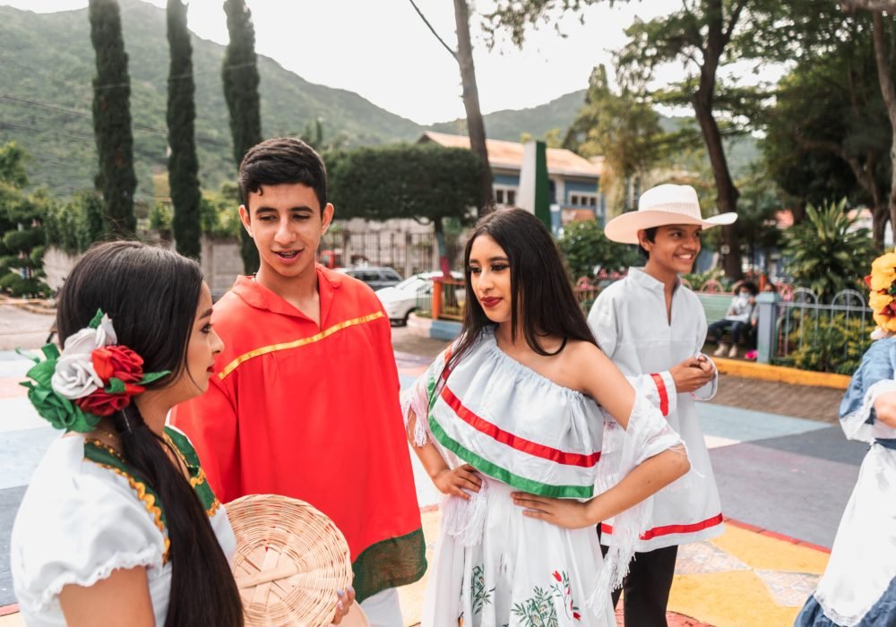 Teenagers from Nicaragua dressed in the classic costume of the national dance talking in a park in Jinotega